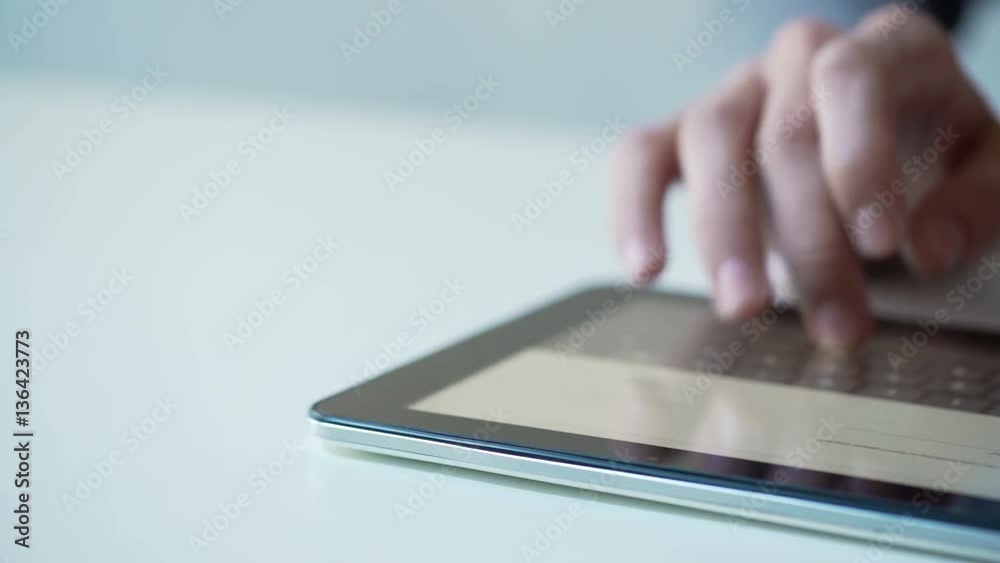 Busy person working on tablet, using mobile app for shopping or booking tickets Busy person working on tablet, using mobile app for shopping or booking tickets