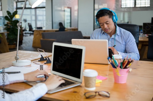 Business executives using laptop at desk © WavebreakMediaMicro