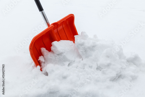 Winter shoveling. Removing snow after blizzard. Shovel which cleaning snow.