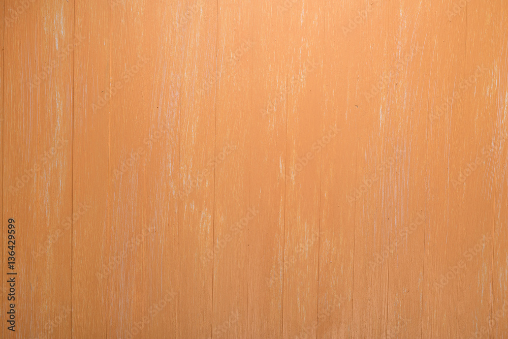 Fototapeta premium Orange wood background. Painted scraped wooden board. Bright texture or pattern.
