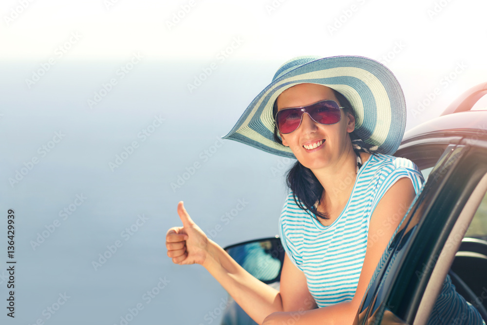 Relaxed happy woman on summer road trip travel vacation showing thumbs up
