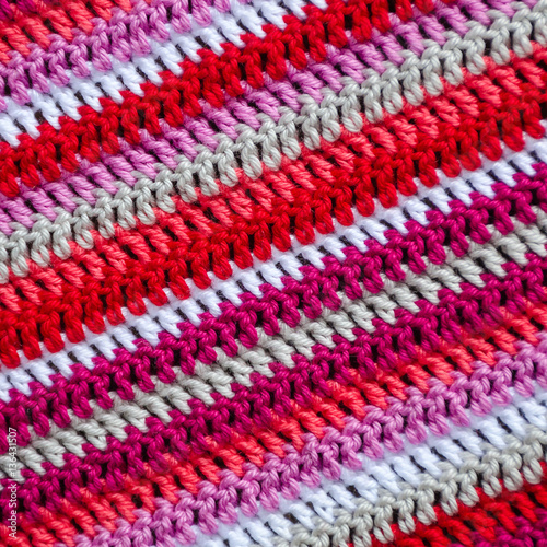 Crochet fabric in white and red colors with a stripes pattern