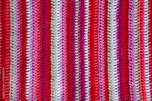 Crochet fabric in white and red colors with a stripes pattern