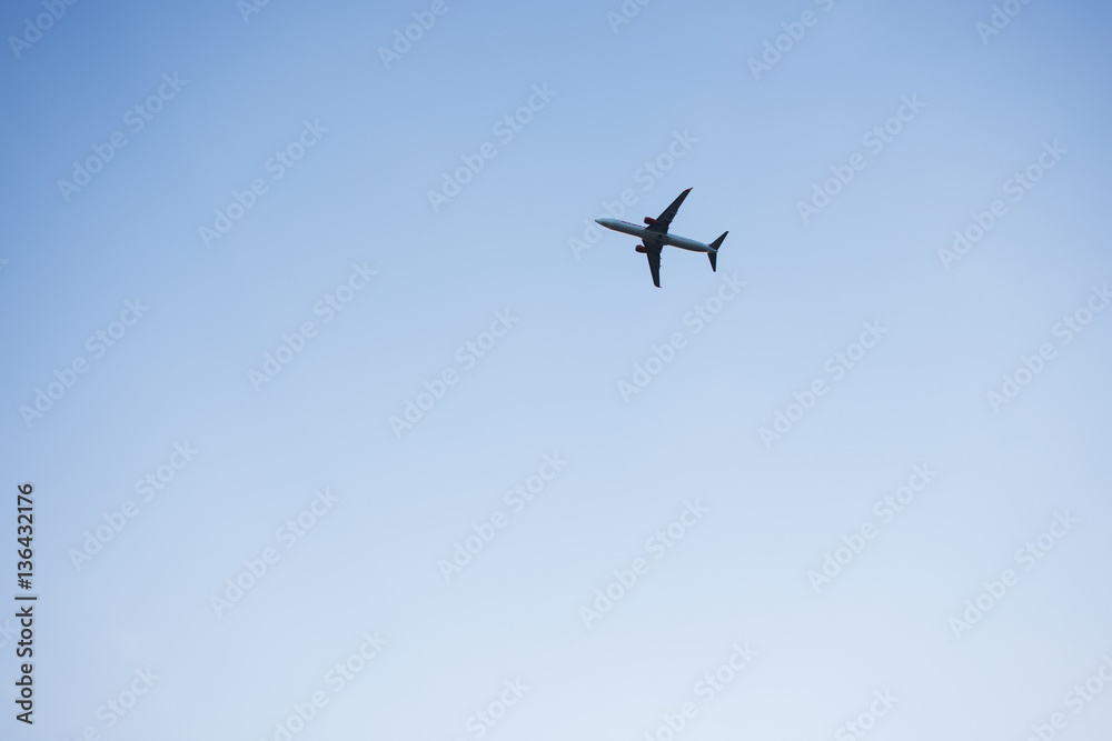 Passenger plane on the background of cloudy sky day.