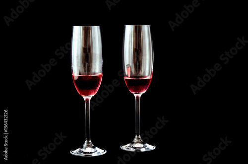 Two glasses with champagne rosè, black background