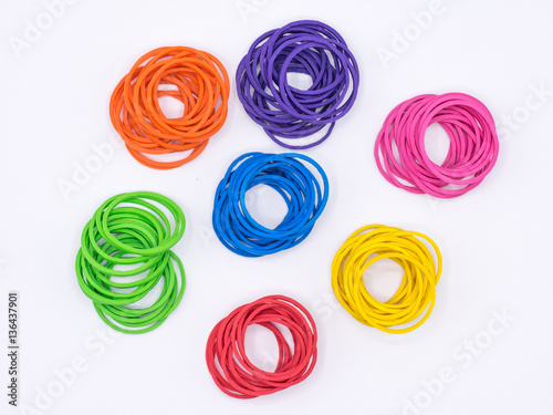 Rubber bands grouped by color on white background