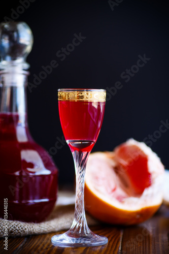 sweet grapefruit alcoholic cordial in the decanter with a glass