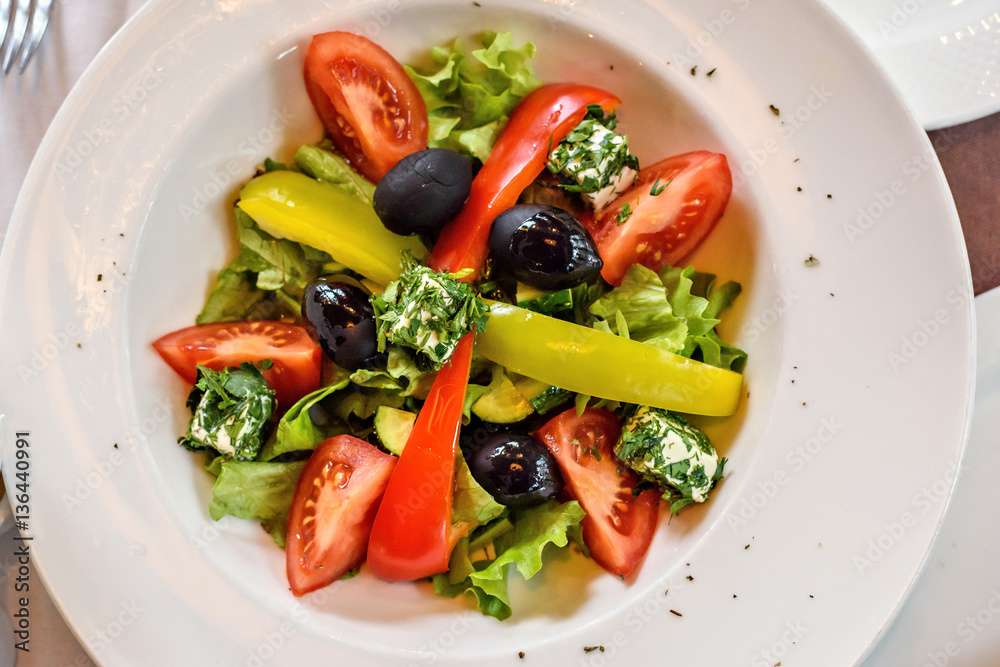 Fresh Greek salad closeup in a restaurant Fresh Greek salad closeup in a restaurant
