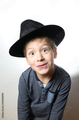 Smiling and wonderstruck boy in the black hat © ondrejschaumann
