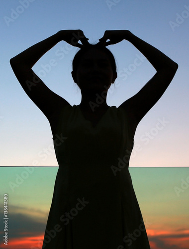 Close up Silhouette of woman expression Heart shape at sunset