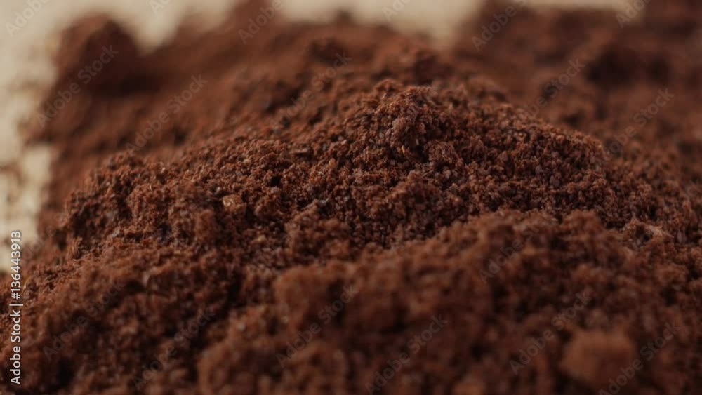 Fine ground coffee powder pile close-up shallow DOF. The slow motion rotation. Fine ground coffee powder pile close-up shallow DOF. The slow motion rotation.