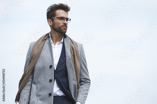 Businessman in overcoat, looking away