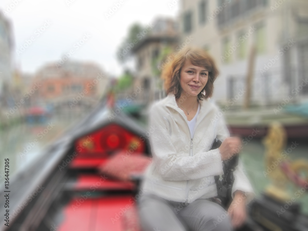 Fototapeta premium Young woman with red hair in gondola, Venice