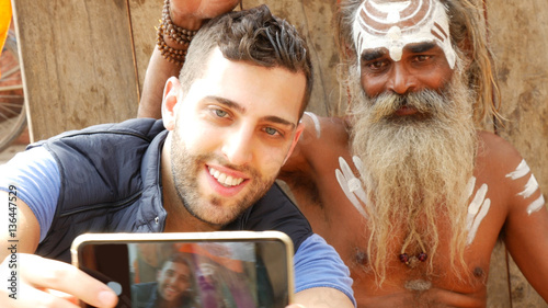 Photography Tourist taking a selfie with Sadhu - Holy Man, in Varanasi, India