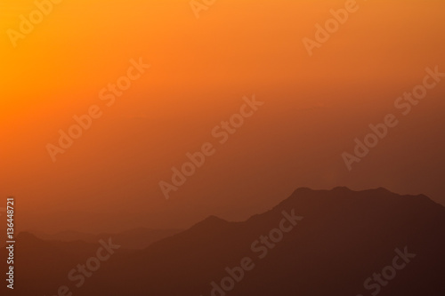 Sunset at the Mountain Hill,Beautiful sunlight, Orange lights background © 9kwan