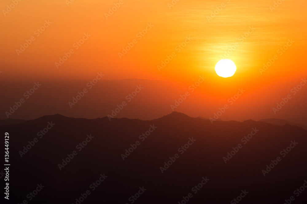 Sunset at the Mountain Hill,Beautiful sunlight, Orange lights background Sunset at the Mountain Hill,Beautiful sunlight, Orange lights background