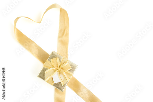 Isolated gold gift box with gold ribbon