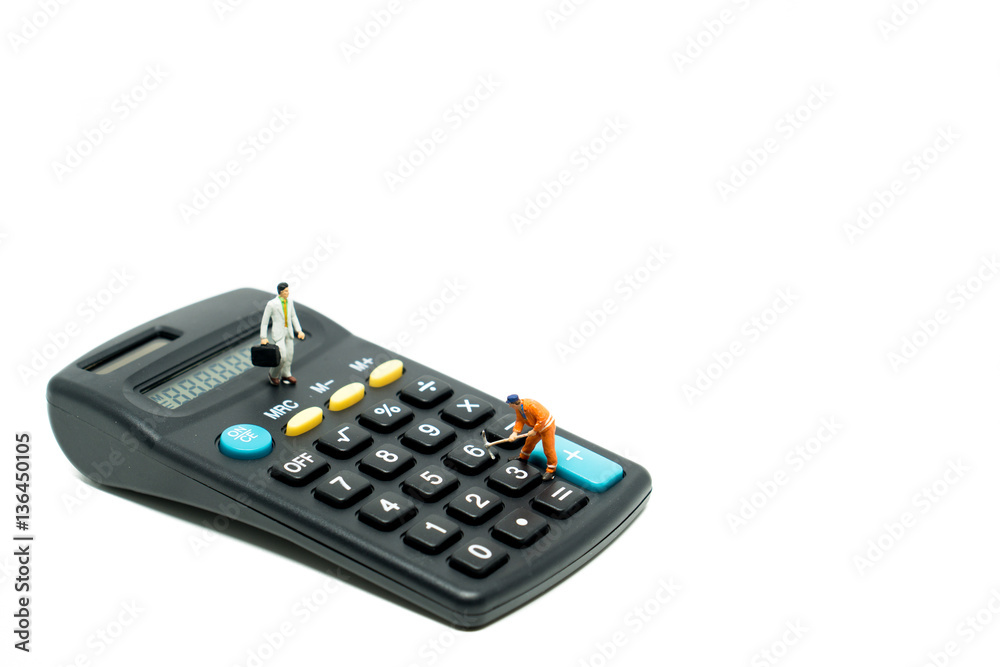 Miniature people businessman and engineer on calculator Miniature people businessman and engineer on calculator