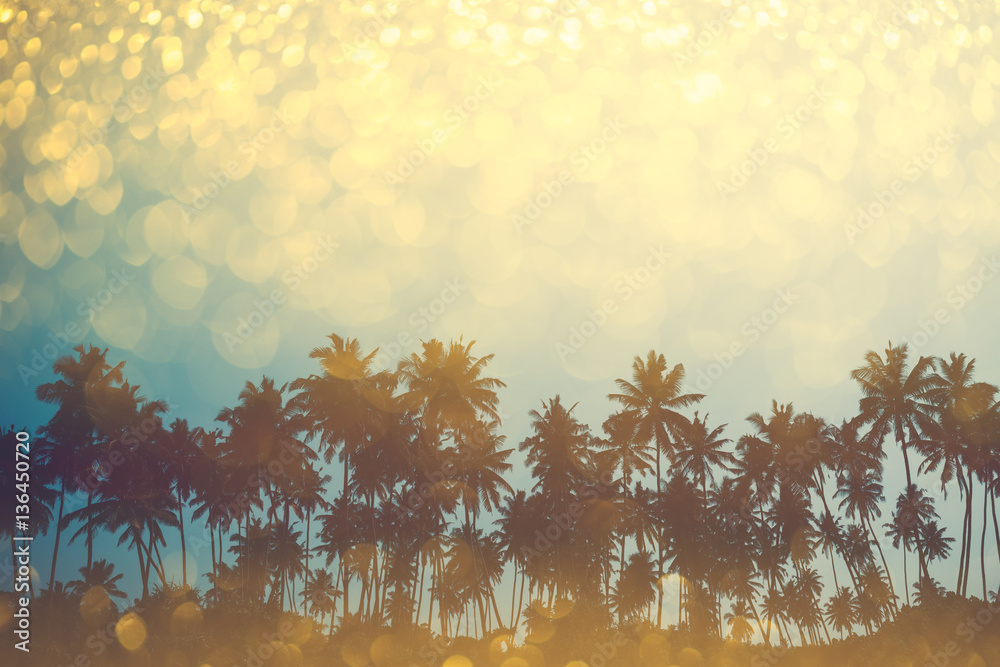 Naklejka premium Palm trees on tropical beach, vintage toned and retro color stylized with shiny party glitter overlay effect