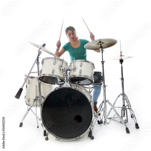 brunette brazilian woman plays the drums in studio