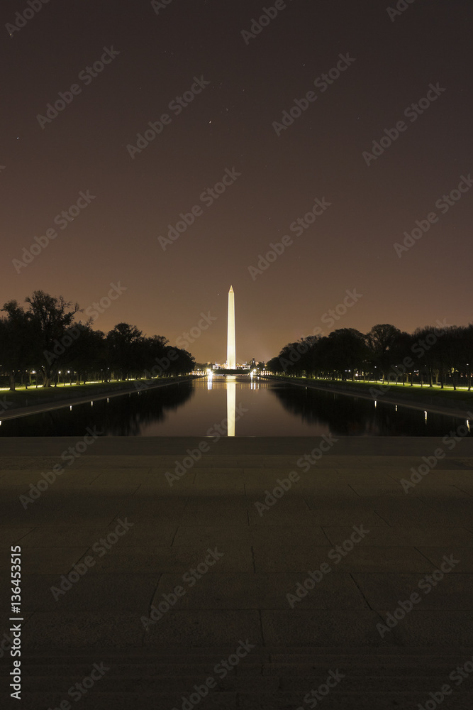Grand night-time view east across the Lincoln Memorial Reflecting Pool towards America's national monument, the Washington Monument, National Mall, Washington DC