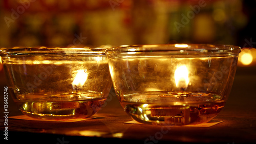 Burning candles in Buddhist temple photo