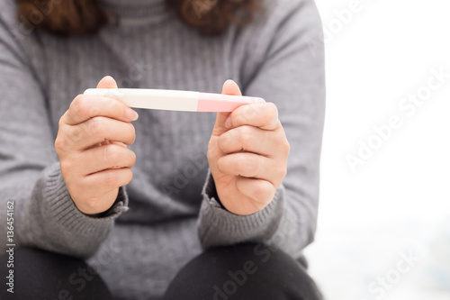 Woman holding pregnancy test  New life and new family concept.