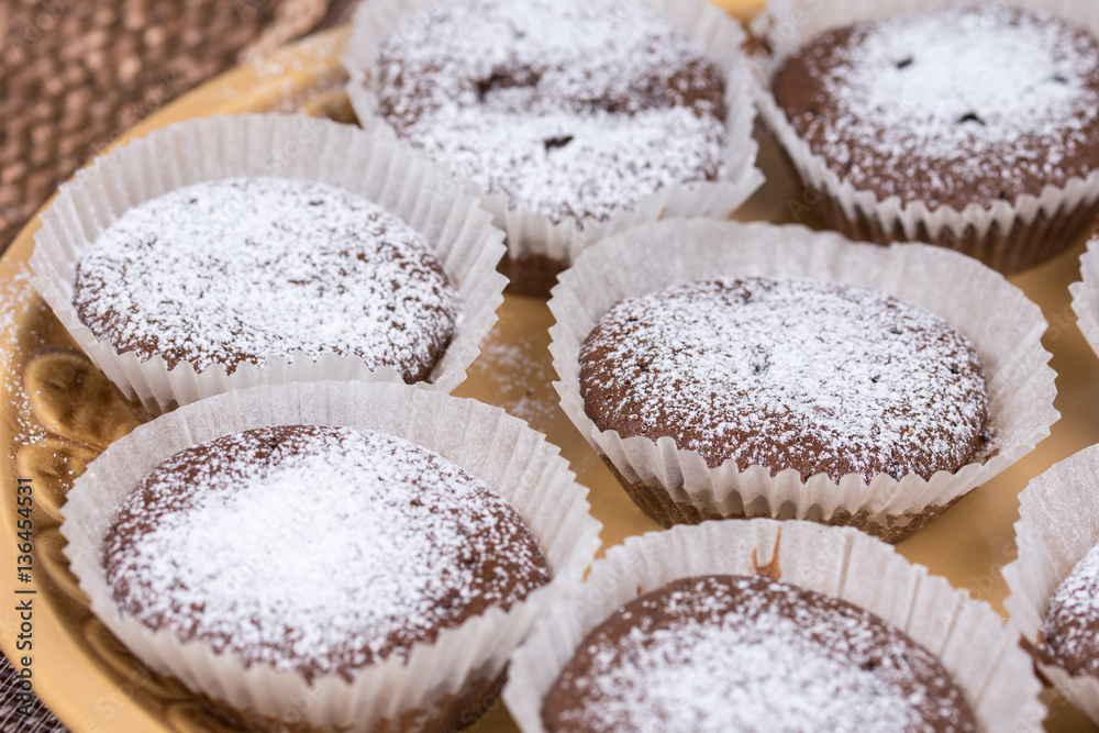 Chocolate cupcake muffin with powdered sugar Chocolate cupcake muffin with powdered sugar
