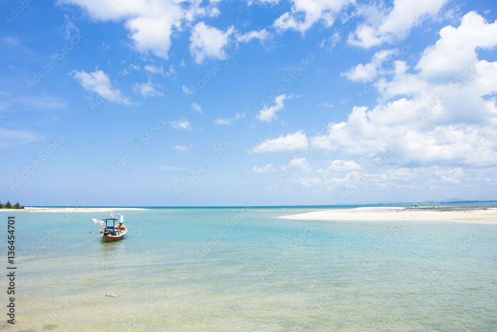 fishing boat on the seascape and cloud in blue sky at asia beach