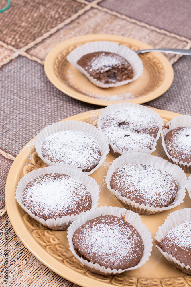 Chocolate cupcake muffin with powdered sugar Chocolate cupcake muffin with powdered sugar