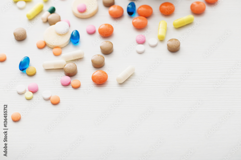 different pills mix on white wooden background different pills mix on white wooden background
