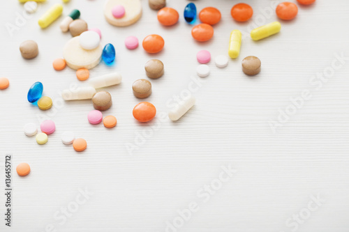different pills mix on white wooden background