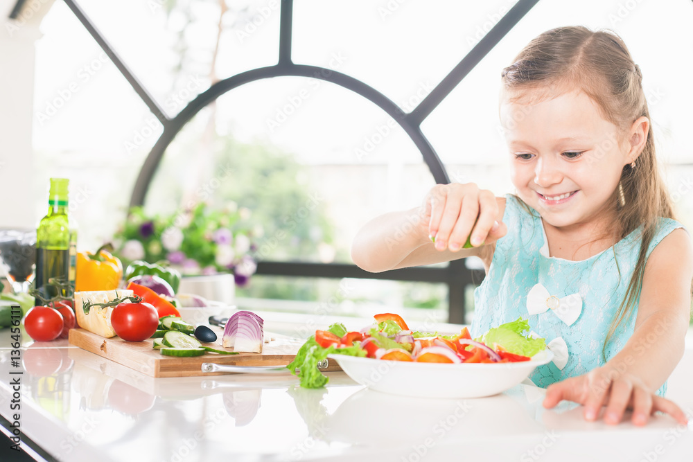 Cute little girl making salad. Child cooking. Healthy food