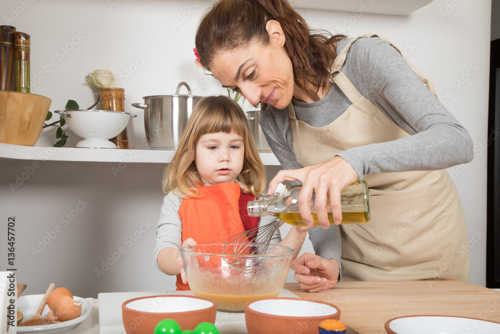 three years old child and woman, in teamwork, making and cooking a sponge cake at kitchen home, pouring olive oil in glass bowl from bottle
three years old child and woman, in teamwork, making and cooking a sponge cake at kitchen home, pouring olive oil in glass bowl from bottle