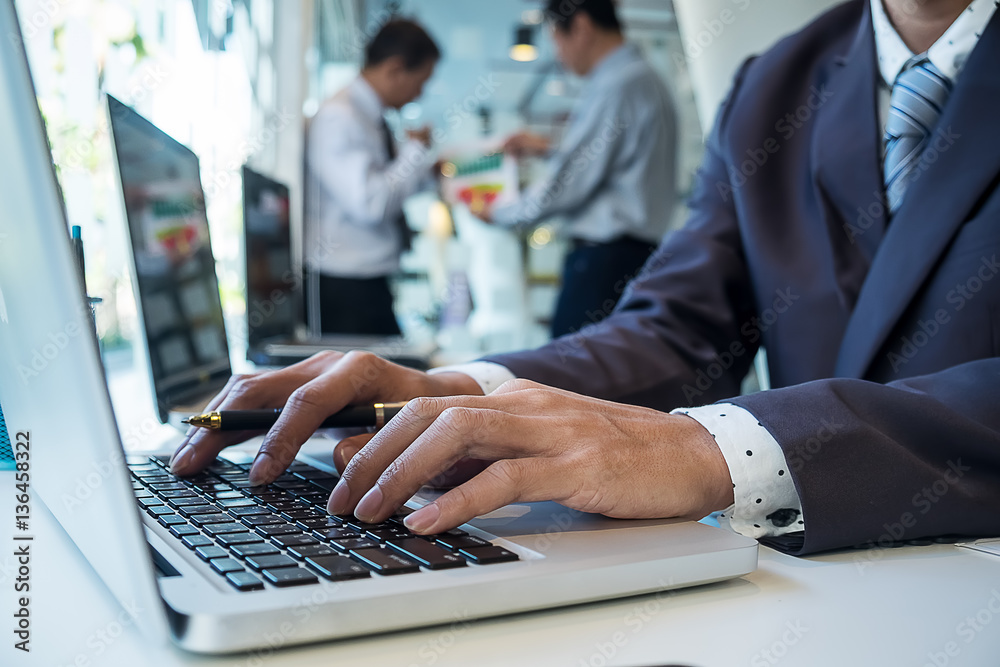 business man using laptop computer on office table with two part business man using laptop computer on office table with two part
