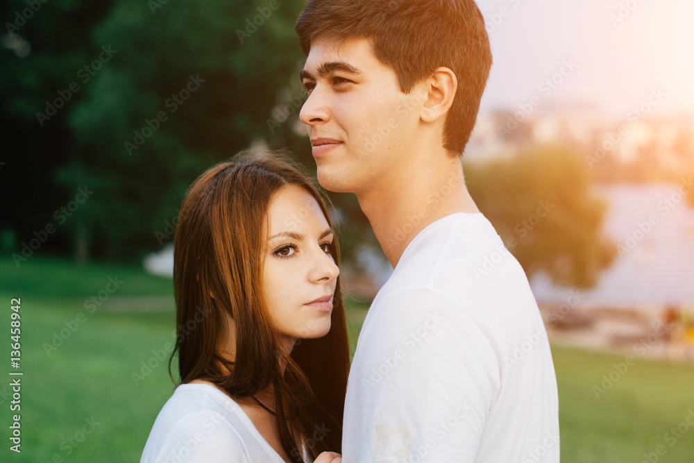 Happy couple in love having fun outdoors hugging kissing and smiling