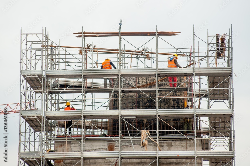 Fototapeta premium workers working on scaffolding