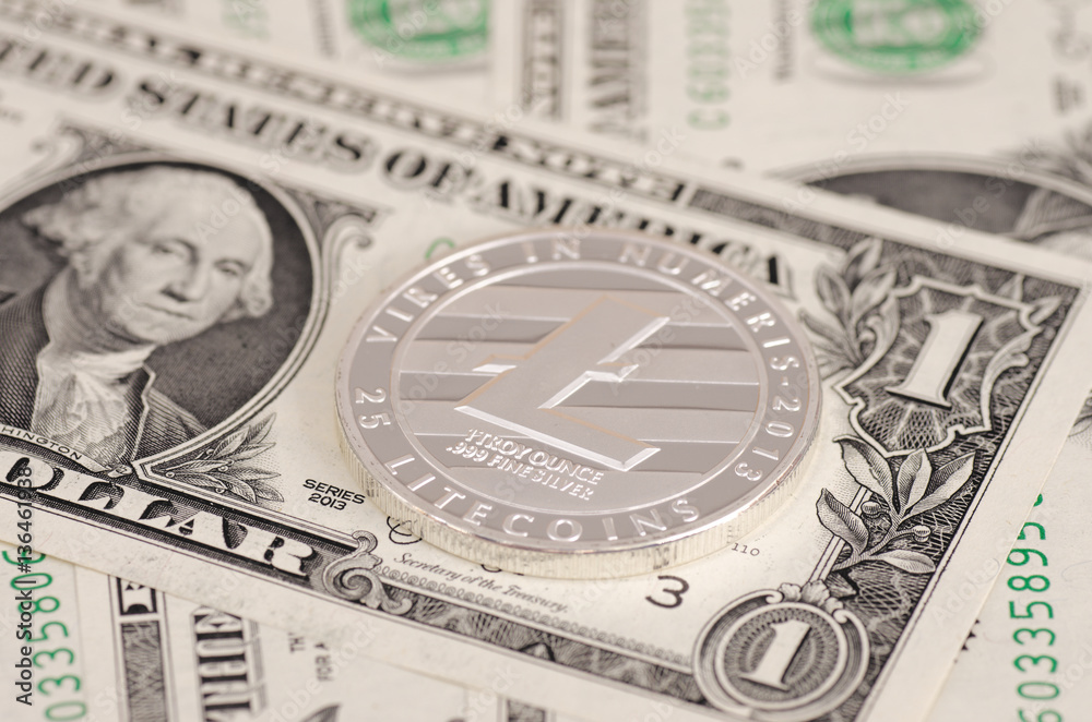 Silver plated Litecoin on one dollar bills. Silver plated Litecoin on one dollar bills.