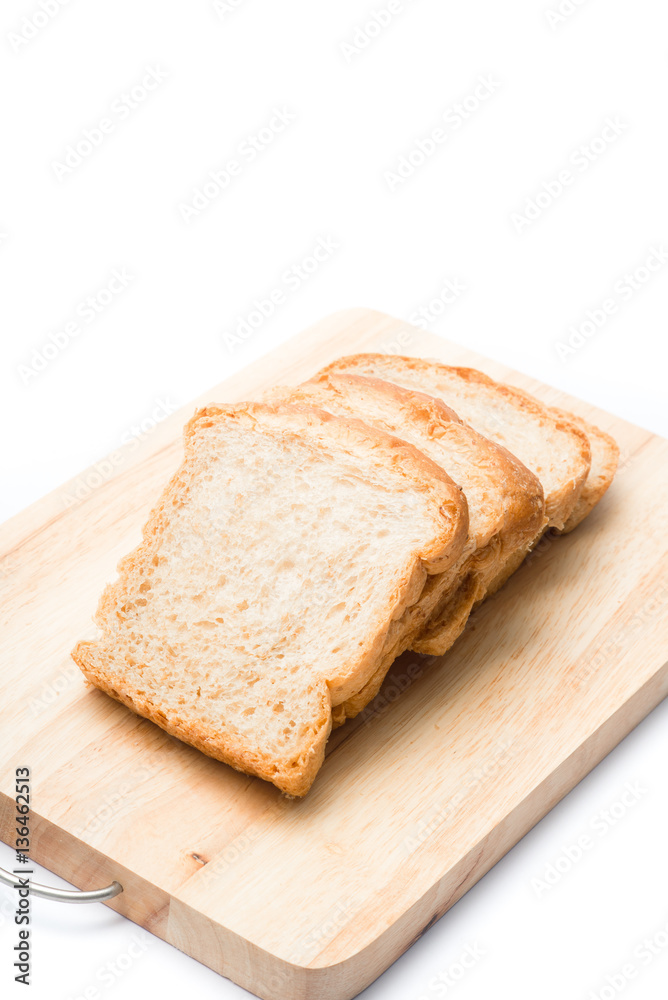 Four pieces of sliced bread on the wooden cutting board on the white background.