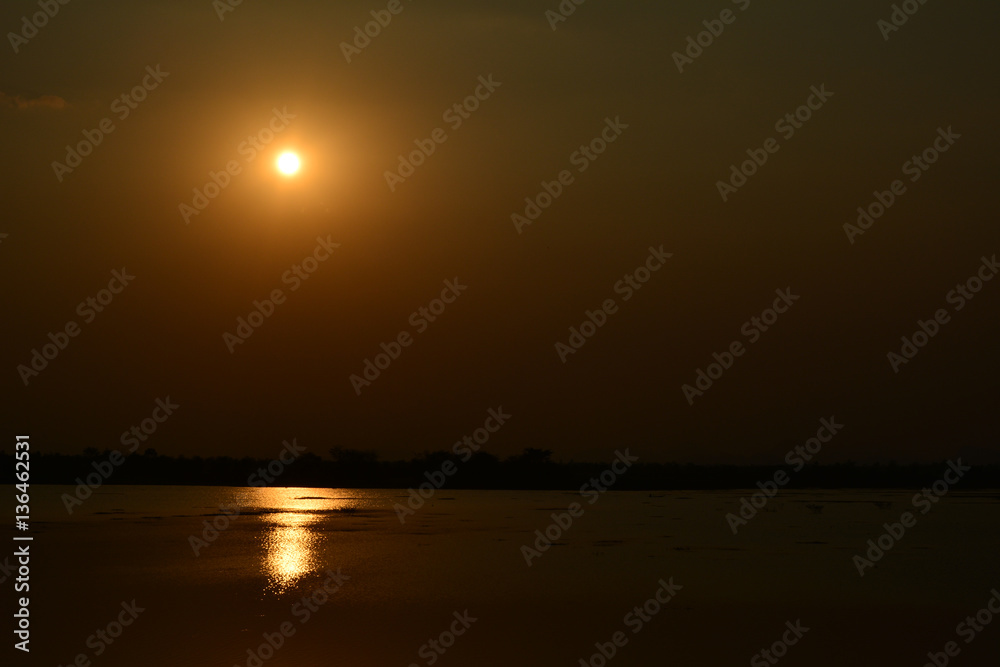 Beautiful sunset landscape and orange sky, sun golden reflection