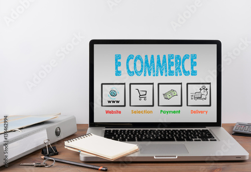 E commerce concept. Office desk with a laptop. Gray background