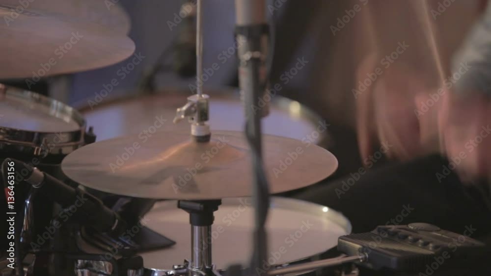 Musician playing rhythmic music at drums and cymbals. Close up at drumkit where drummer dressed up in shirt and tie plays rhythmic music at drums and cymbals. Musician playing rhythmic music at drums and cymbals. Close up at drumkit where drummer dressed up in shirt and tie plays rhythmic music at drums and cymbals.