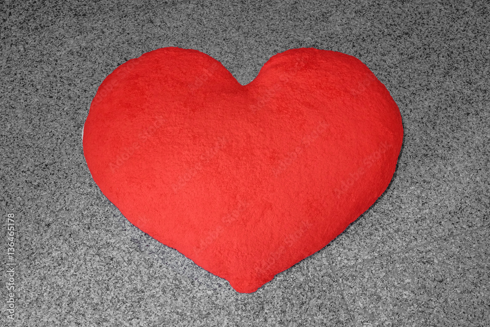 Valentine red heart-shaped pillow on the marble floor Valentine red heart-shaped pillow on the marble floor