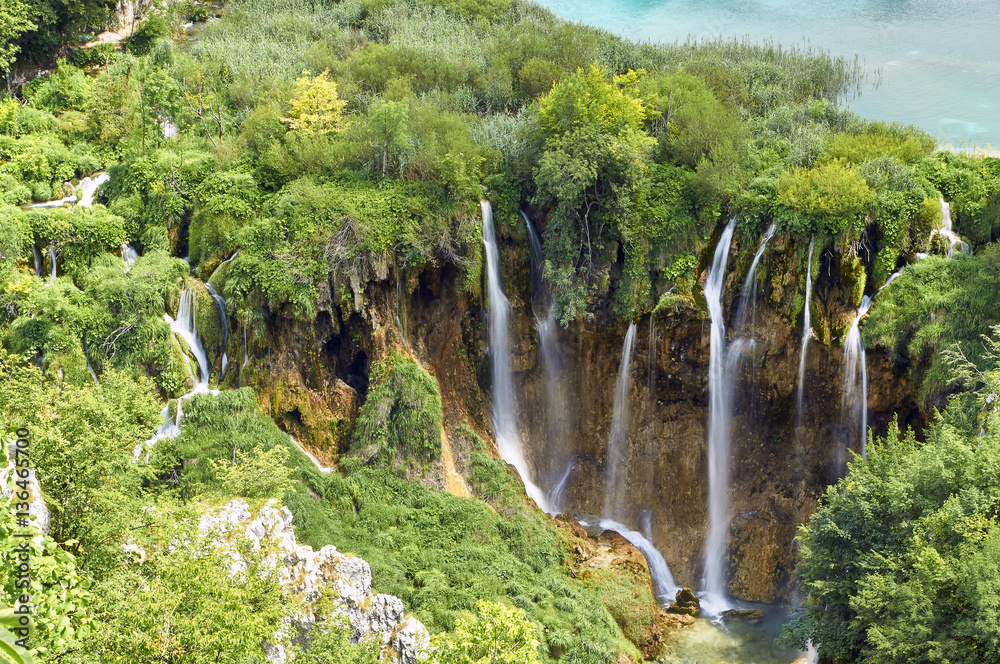 Obraz premium Plitvice Lakes in Croatia Beautiful waterfalls surrounded by greenery, summer vacation