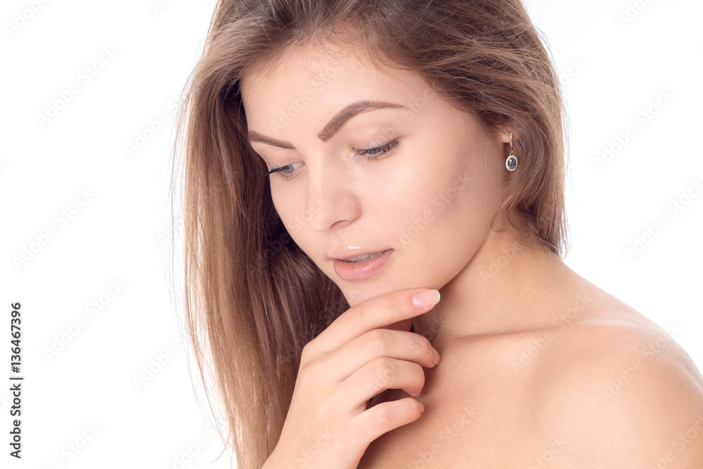 Portrait of a young attractive girls without makeup that looks down and keeping his hand near the face close-up Portrait of a young attractive girls without makeup that looks down and keeping his hand near the face close-up