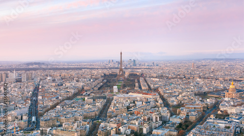 Aerial panoramic view of Paris skyline with Eiffel Tower, Les Invalides and business district of Defense at pink sunset, as seen from Montparnasse Tower, Paris, France © Kavalenkava