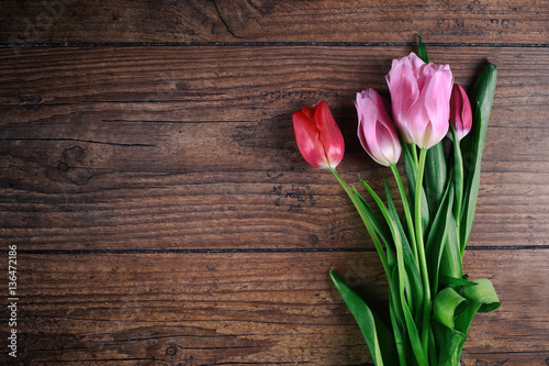 Pink Tulip Flowers on rustic table for March 8, International Womens Day, Birthday, Valentines Day or Mothers day - Top View