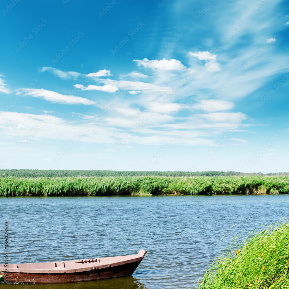 river with boat and blue sky with clouds river with boat and blue sky with clouds