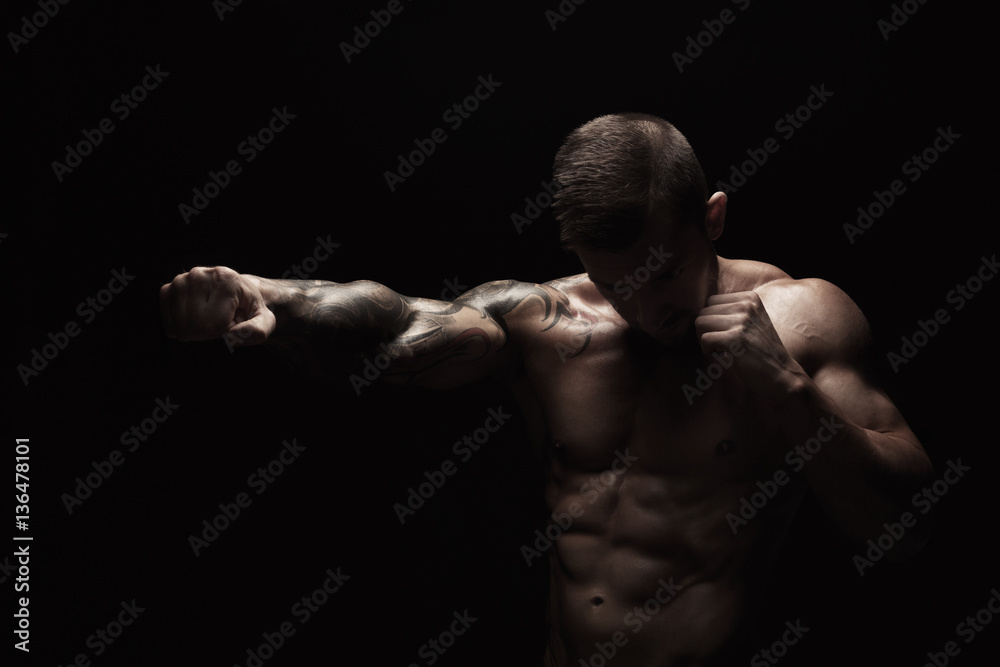 Strong athletic man showes naked muscular body Strong athletic man showes naked muscular body