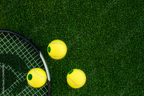 tennis racket on green background top view